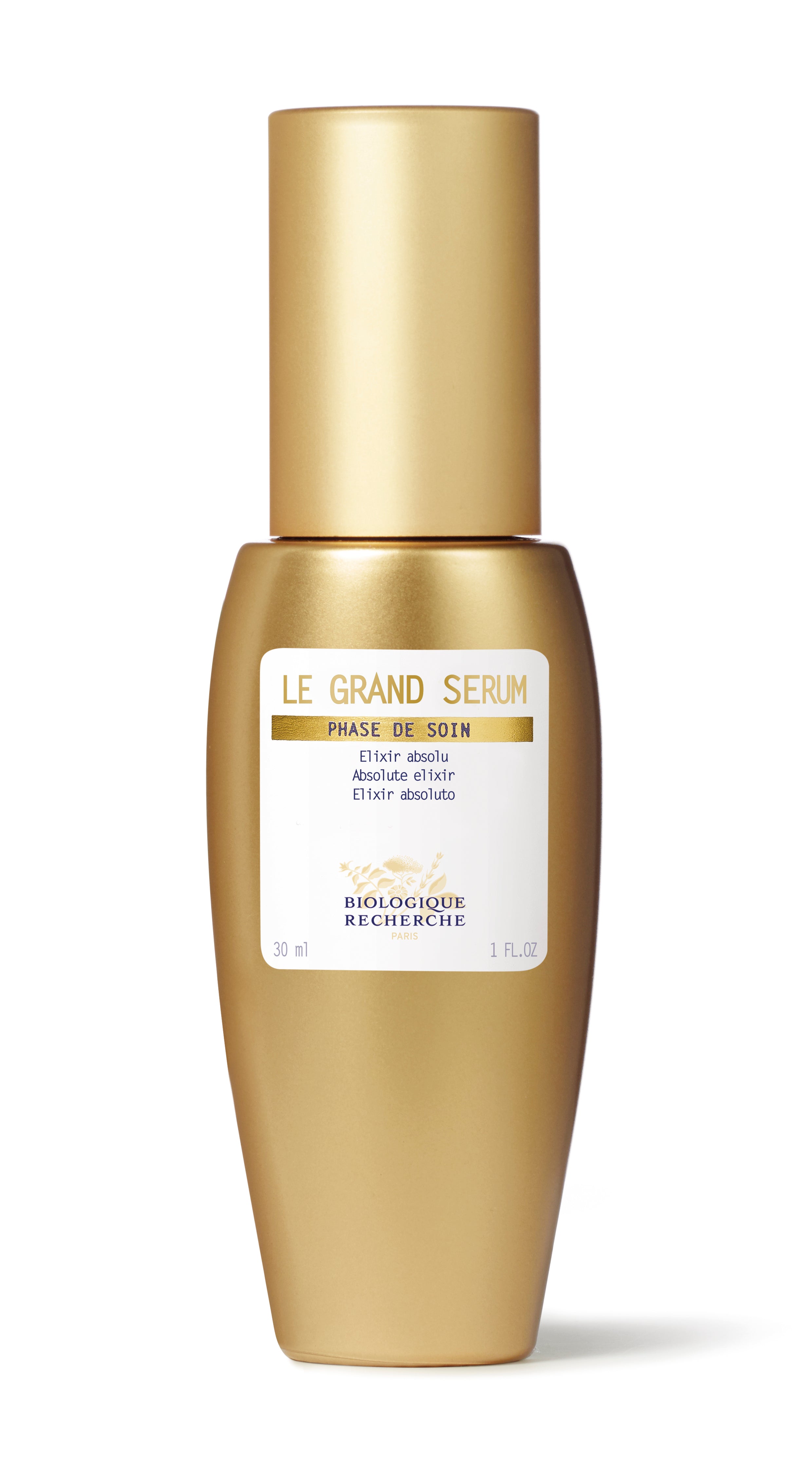 Gold cylindrical bottle of Le Grand Sérum with white label and gold cap.